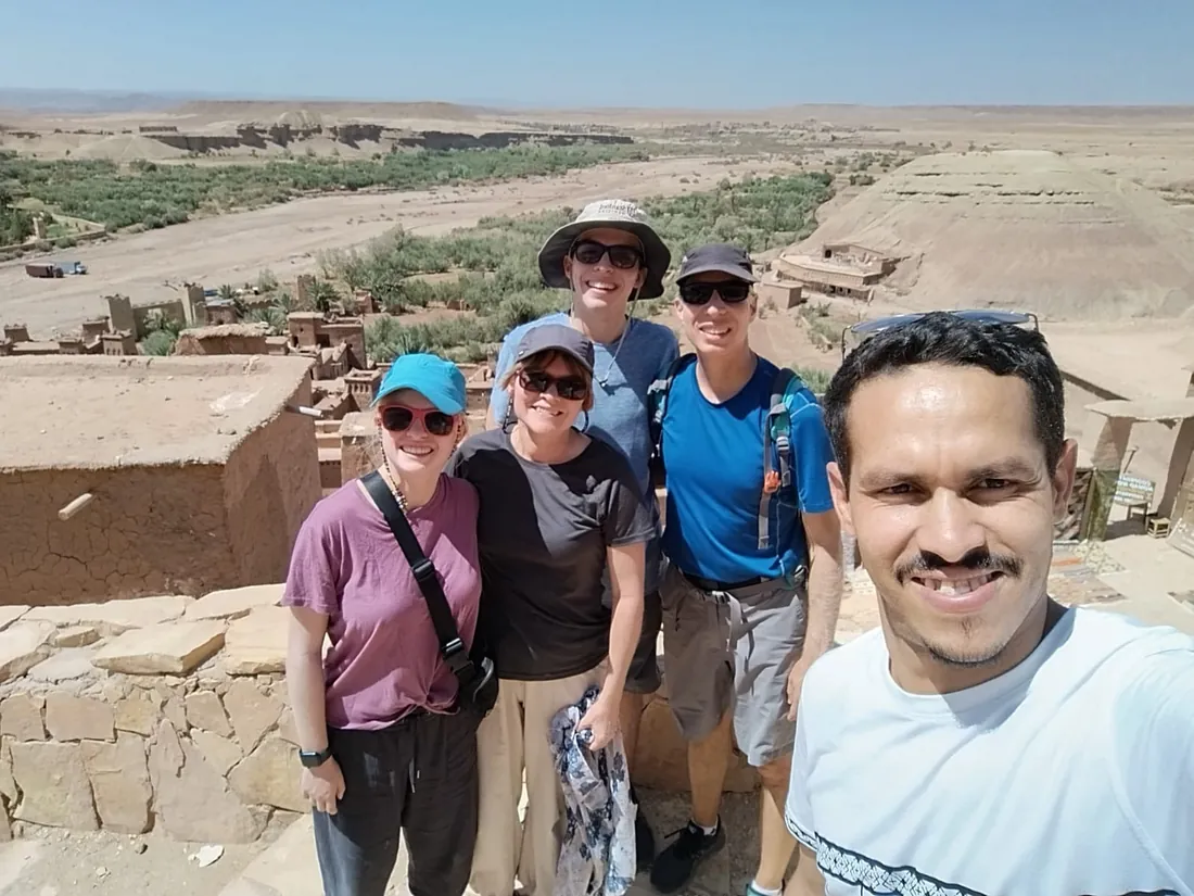 One of our guides taking a selfie with guests above the valley at Aït Benhaddou
