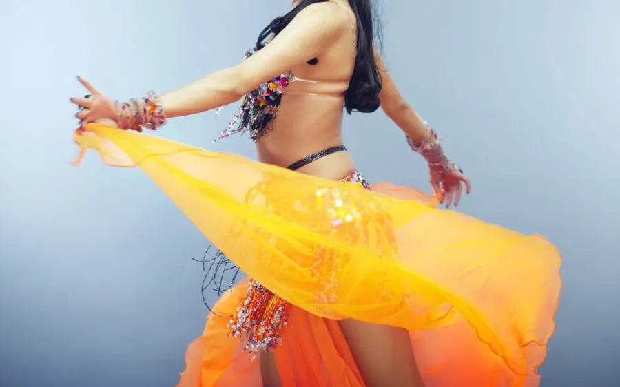 A dancer performing with a silk veil during a dinner show