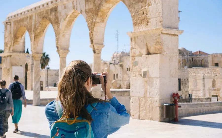 A traveller photographing ancient arches in Morocco