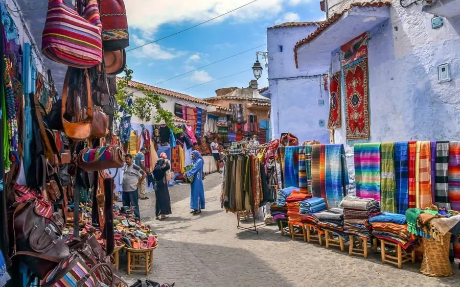 Woven blankets and crafts for sale in a blue-painted street