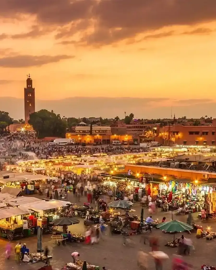 Jemaa el-Fna square in Marrakech glowing at dusk
