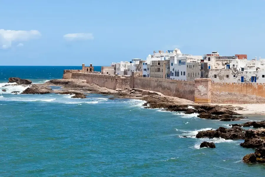 The white town of Essaouira behind its ocean ramparts