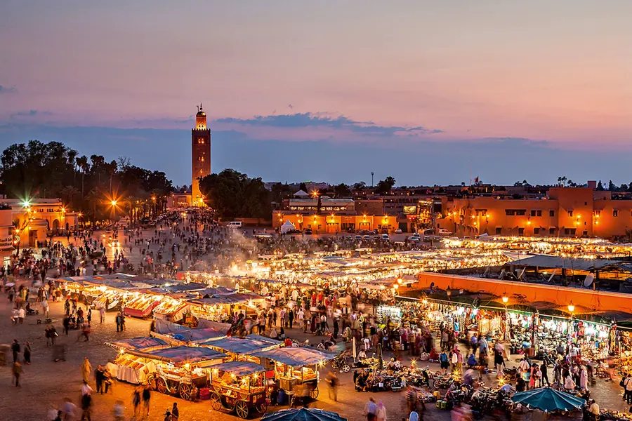 Jemaa el-Fna square lit up at dusk