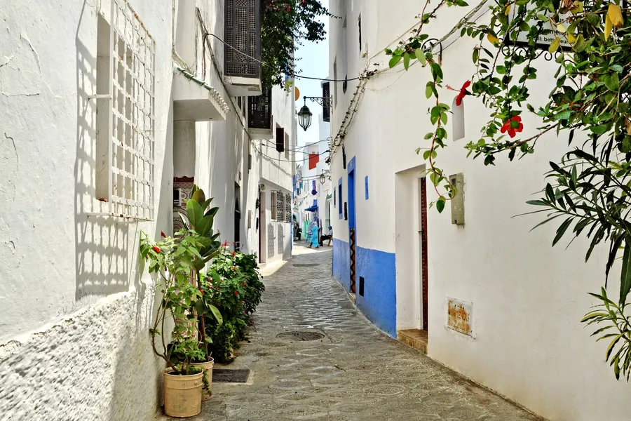 A whitewashed lane with blue doors in the medina of Asilah