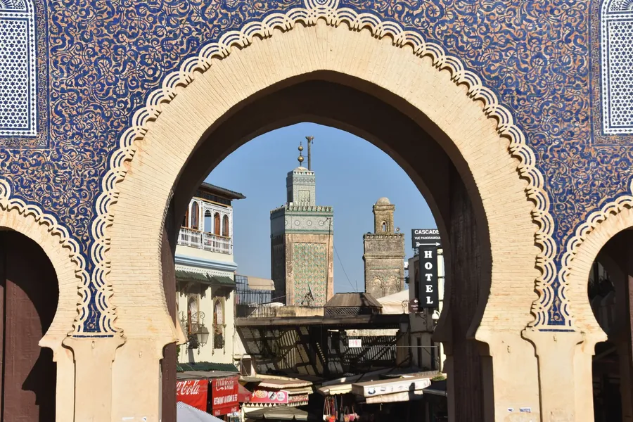 A view of minarets through the tiled arch of Bab Boujloud in Fes