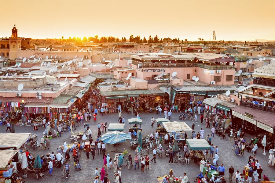 Jemaa el-Fna square in Marrakech filling with food stalls at sunset