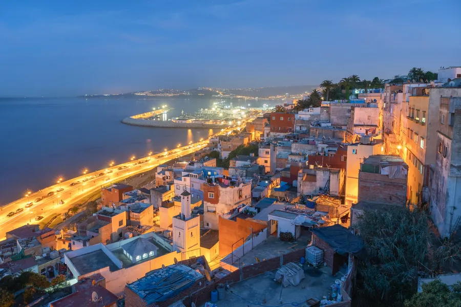 The white city of Tangier above its bay at dusk